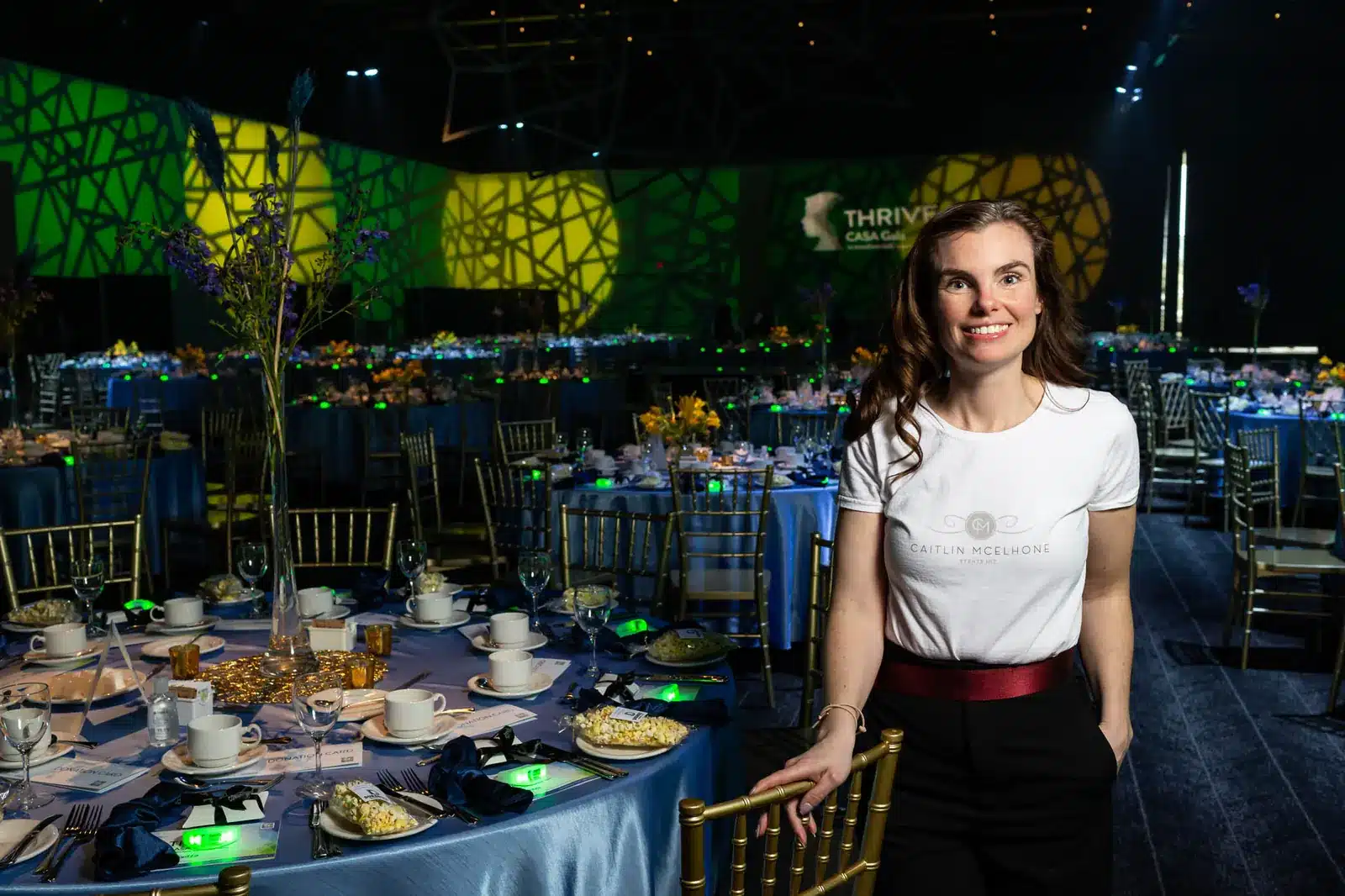 edmonton-portrait-photographer-CASA-Gala_073-1600 Event planner Caitlin Mcelhone standing beside decorated gala table during Edmonton charity event setup