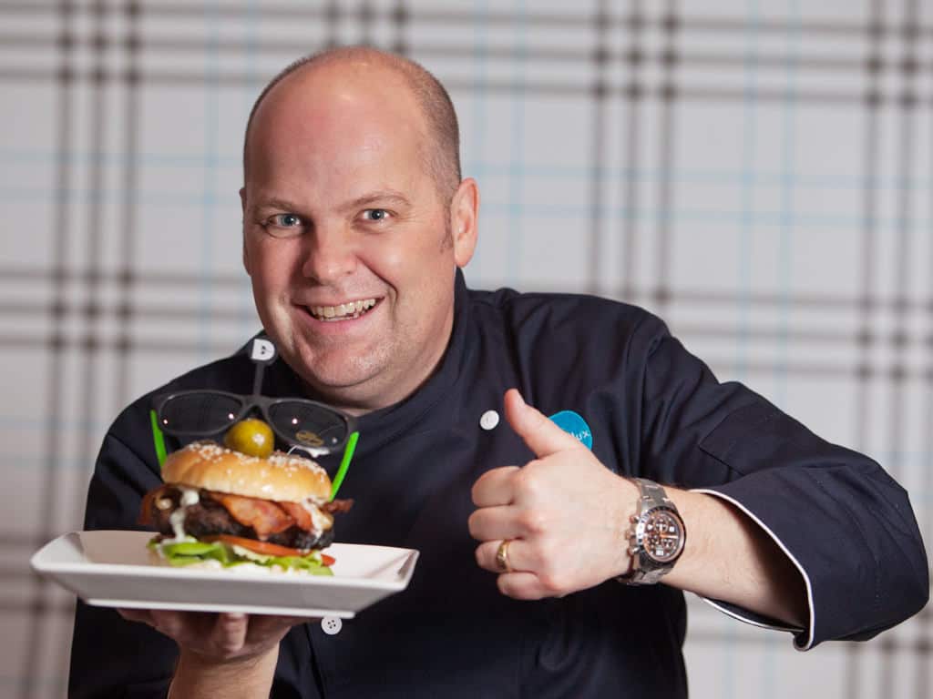 edmonton-commercial-photography-garner-andrews-celebrity-chef-delux Garner Andrews from Sonic 102.9 poses with his celebrity burger creation for Delux Burger's Celebrity Chef campaign