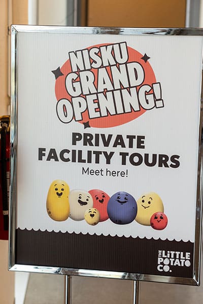 edmonton-commercial-photography-little-potato-company-grand-opening-signage Edmonton Commercial Photography - signage directs guests to the location of facility tours for the grand opening of the Little Potato Companys's grand opening in Leduc