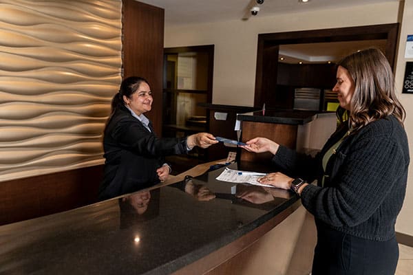edmonton-commercial-photography-stock-imagery-alberta-hotel-lodging-association Edmonton Commercial Photography - front desk staff assist a guest checking into the hotel